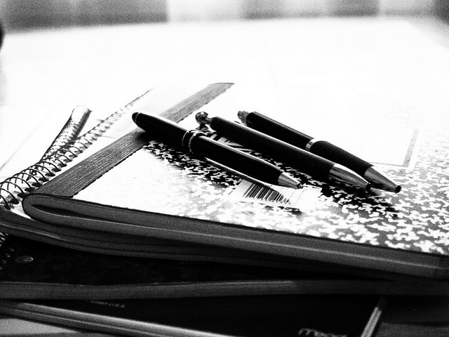 3 pens on a composition book